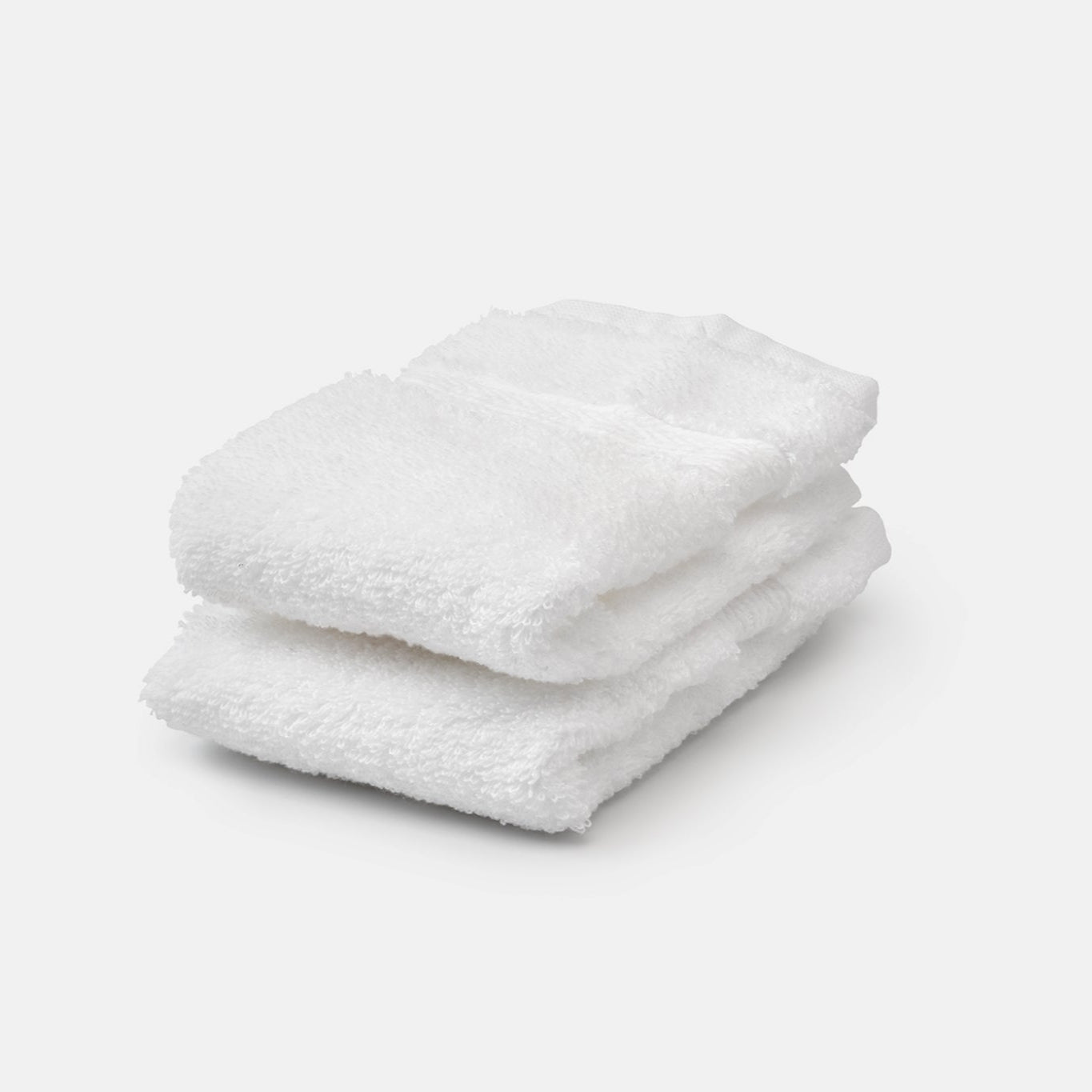 two white organic cotton washcloths stacked