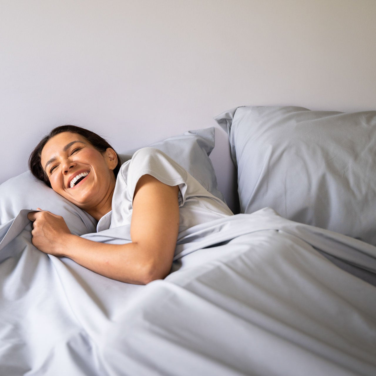 Woman_in_Bed_ American Blossom Linens Grey Sheet