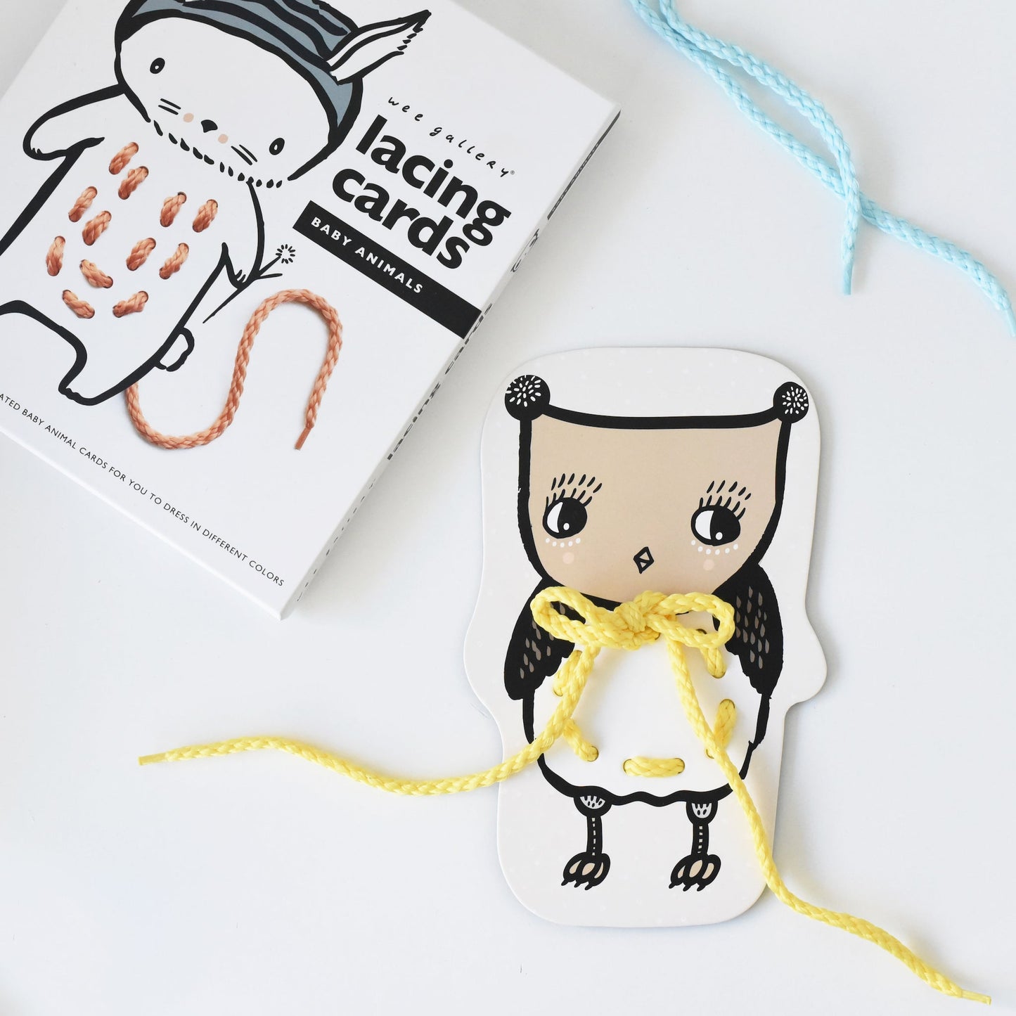 Lacing card with a lacing string, next to a box labeled 'lacing cards & easy animals'.