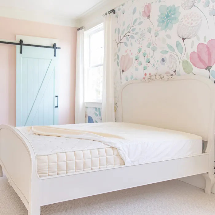 Naturepedic-organic-waterproof-mattress-protector-on-bed