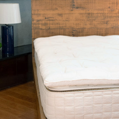 Wooden bed with a Wooly 3" Organic Wool Mattress Topper in a bedroom setting