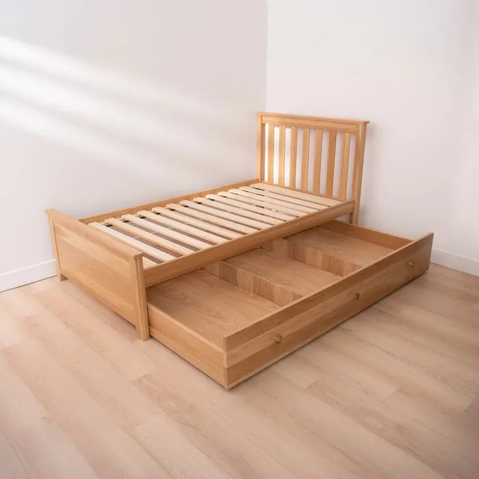 Wooden bed with a drawer in a minimalistic room
