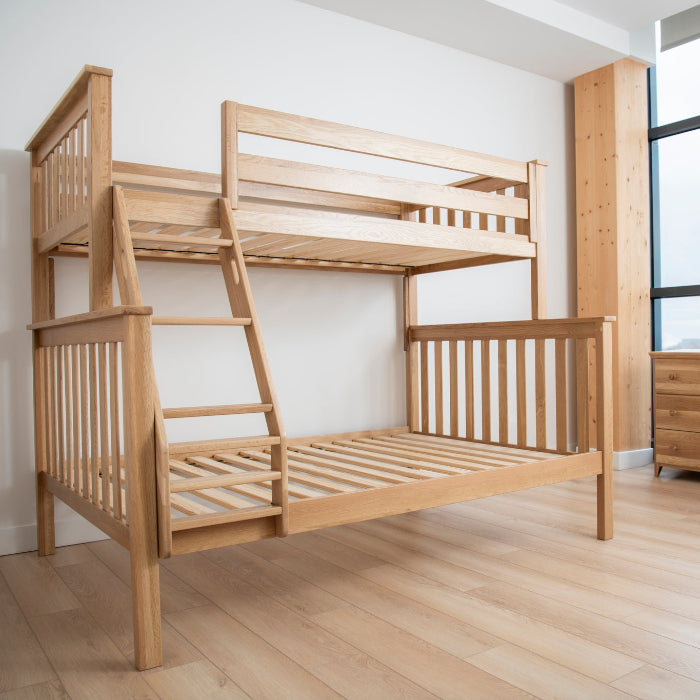 Wooden bunk bed in a room with large windows
